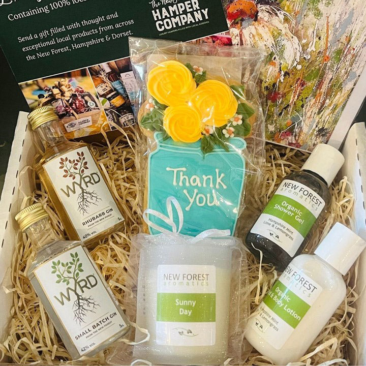 Gift hamper with products from New Forest and WARD, including soap, lotion, and bath oil.